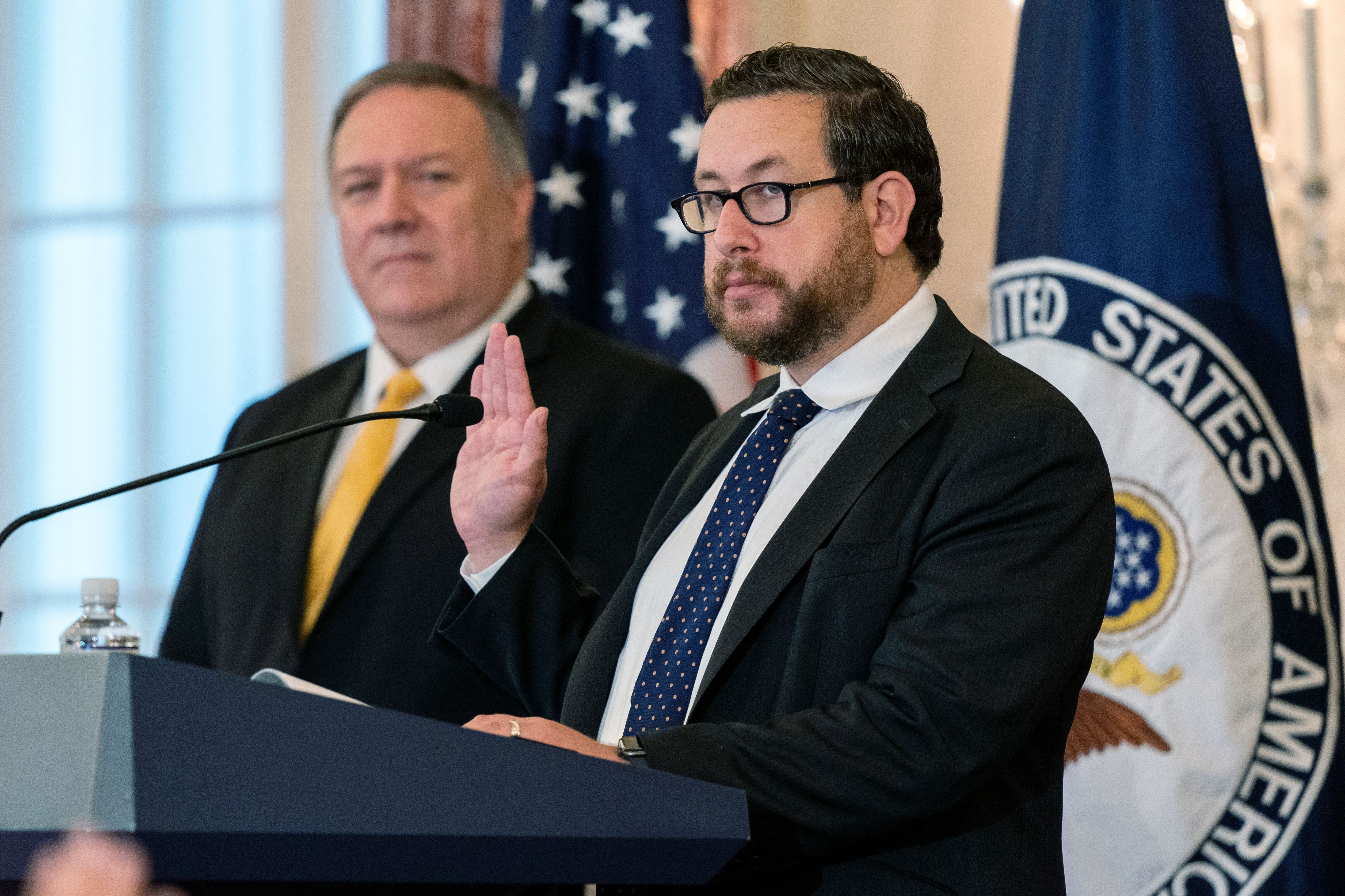 Joseph Edlow (R), now the U.S. Citizenship and Immigration Services director, administers the Oath of Allegiance to twelve candidates for U.S. citizenship during a naturalization ceremony hosted by the USCIS at the State Department in October 2020.
